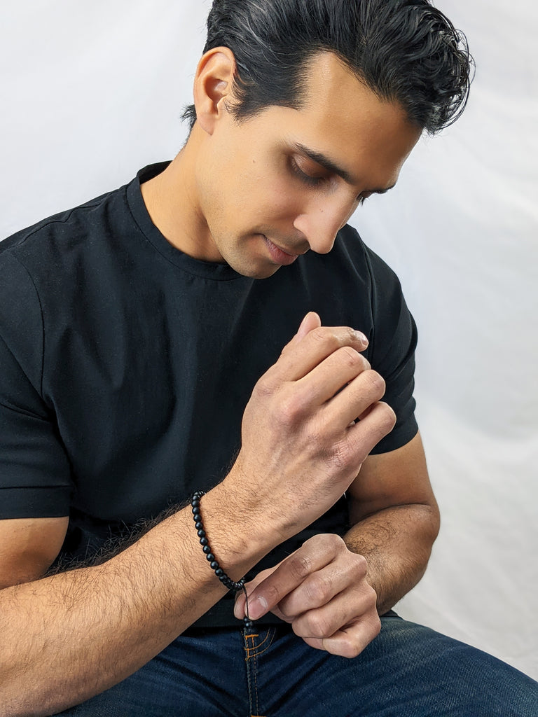 Man wearing tasbih bracelet with 33 beads