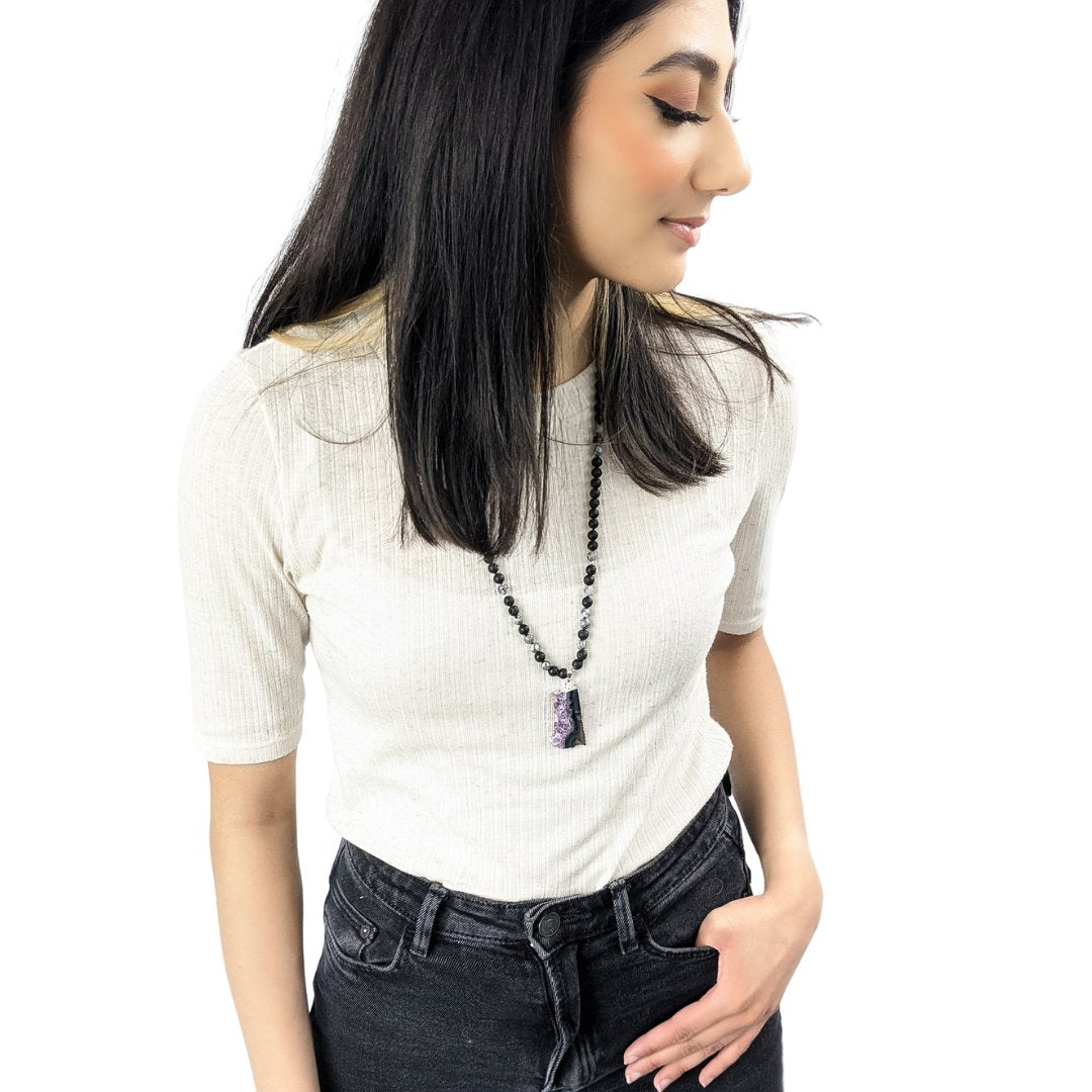 Girl wearing pendant islamic prayer beads with 99 natural tasbih beads featuring unique pendants
